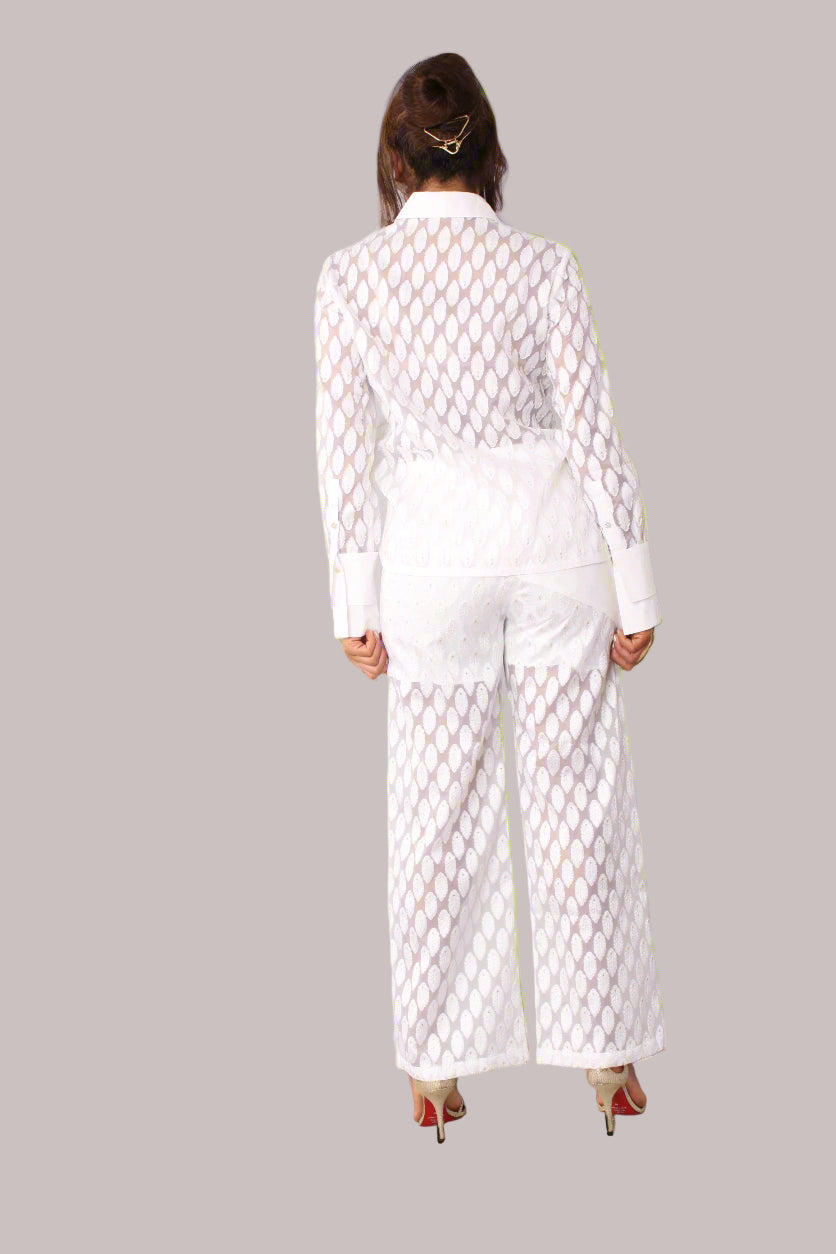 Eyelet wide-leg pants style 82339 in white shown from the back in a standing pose highlighting the full-length wide-leg design and eyelet detailing by For Her NYC
