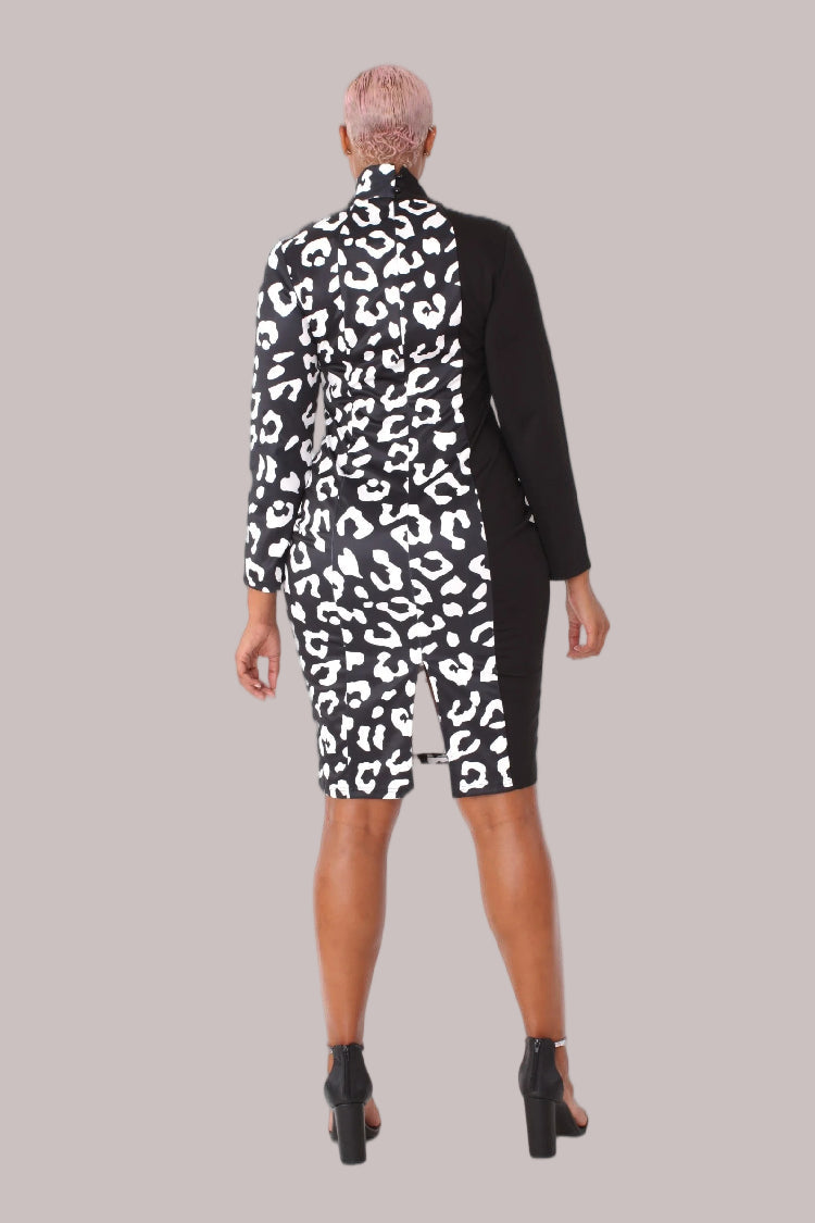 Model wearing black and white leopard print midi dress with bow collar, front walking pose showcasing movement and statement leopard print panel by For Her NYC