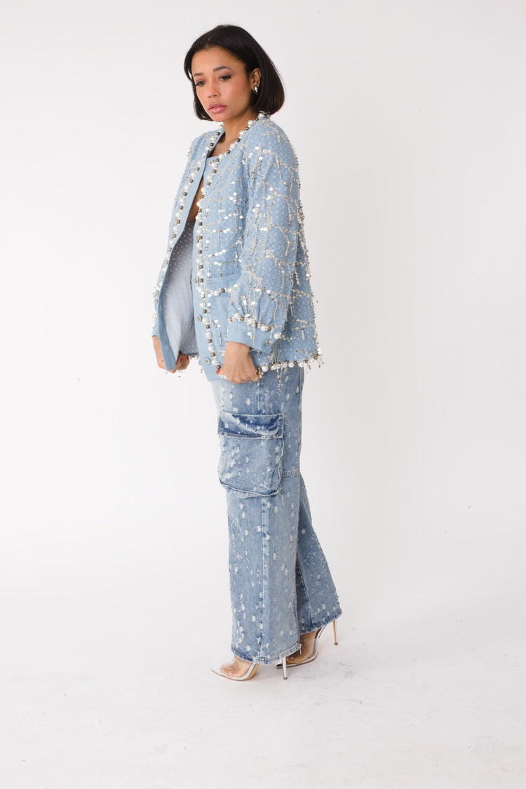 Blue denim jacket with sequins and pearl embellishments shown in side profile, styled with wide leg denim, For Her NYC
