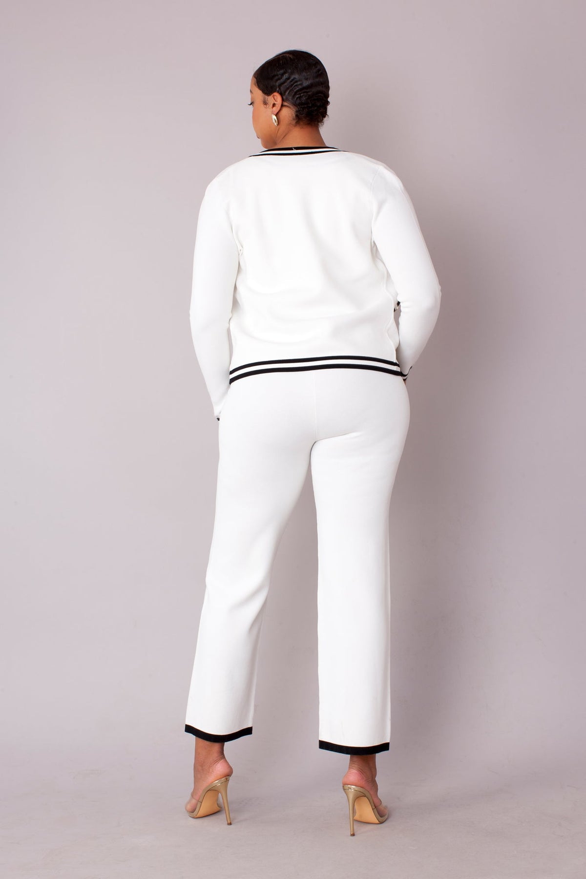 Contrast trim knit three piece set in white with contrast piping, back standing view of cardigan and pants by Tally Taylor