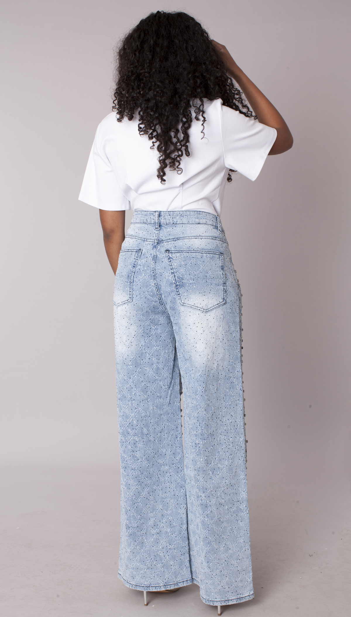 Back view of light wash ombre wide leg jeans with sparkling diamond stud details and high-rise fit – For Her NYC