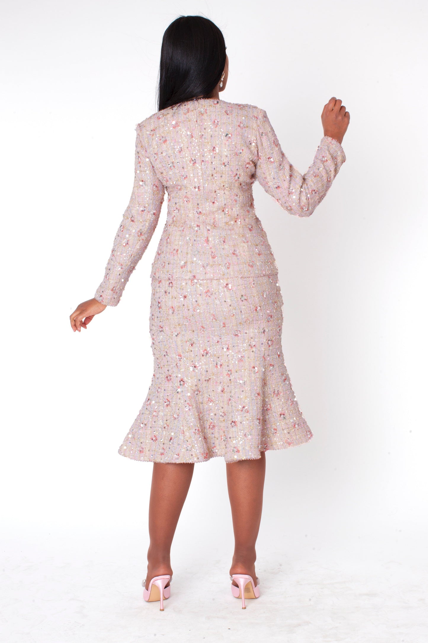 Back view of model wearing the blush embroidered sequin tweed jacket and skirt set highlighting textured tweed fabric, elegant fit, and coordinated silhouette by Tally Taylor