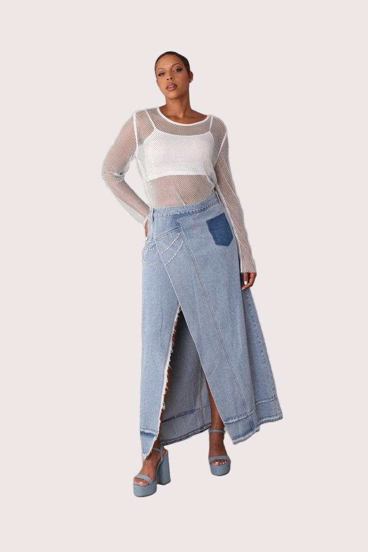 Front walking pose of light wash long denim skirt with side slit and crystal details, showcasing movement and flow of the skirt, For Her NYC