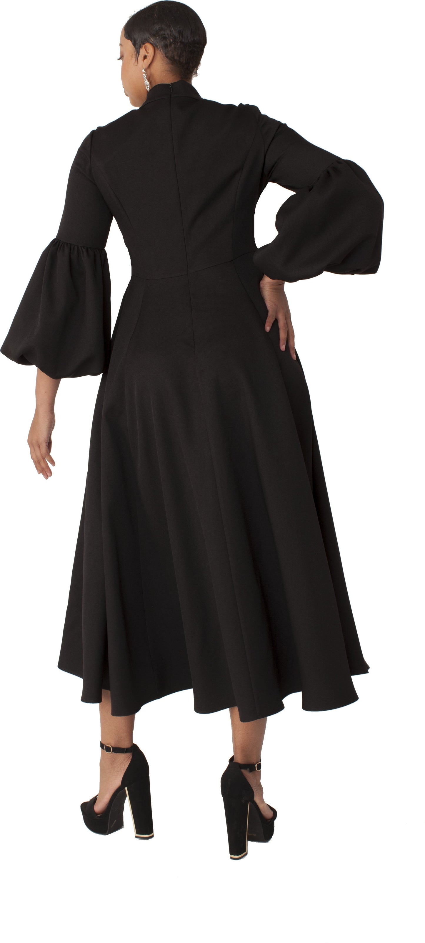 Modest clergy dress with bell sleeves shown in walking pose, black with white accents, Tally Taylor