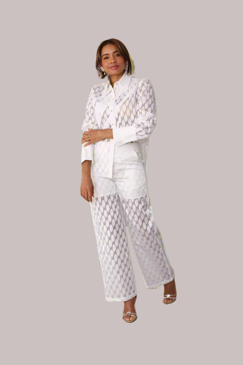 Eyelet wide-leg pants style 82339 in white shown from the front in a standing pose highlighting the eyelet fabric and relaxed wide-leg silhouette by For Her NYC