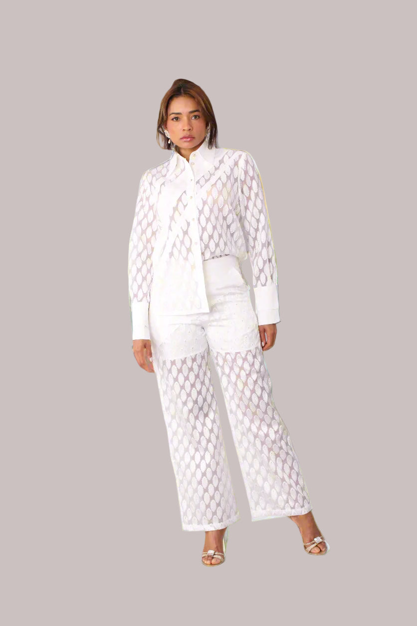 Eyelet wide-leg pants style 82339 in white shown from the front in a walking pose showcasing movement, lightweight eyelet fabric, and breezy fit by For Her NYC