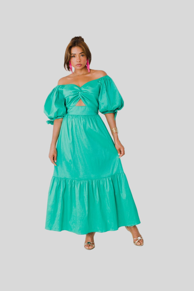 Sage Garden Party maxi dress style 82358 in emerald shown from the front in a standing pose highlighting the off-shoulder neckline, puff sleeves, and tiered skirt by For Her NYC