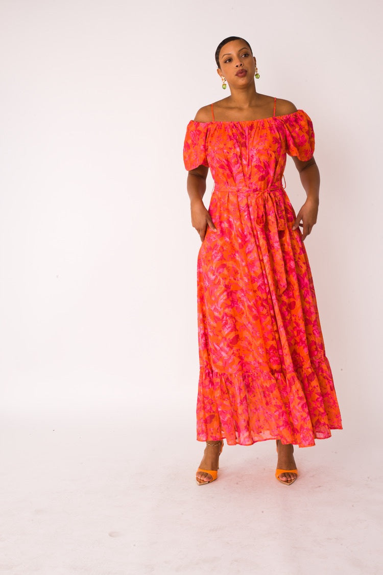 Sunset Bloom maxi dress style 82376 in multi print shown in a forward walking pose emphasizing the fluid movement and watercolor floral pattern by For Her NYC
