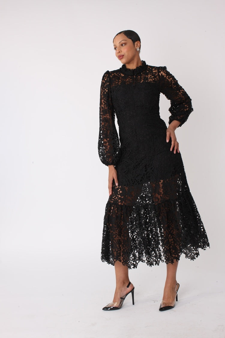 Side view of black lace midi dress with long sleeves and scalloped hem, For Her NYC