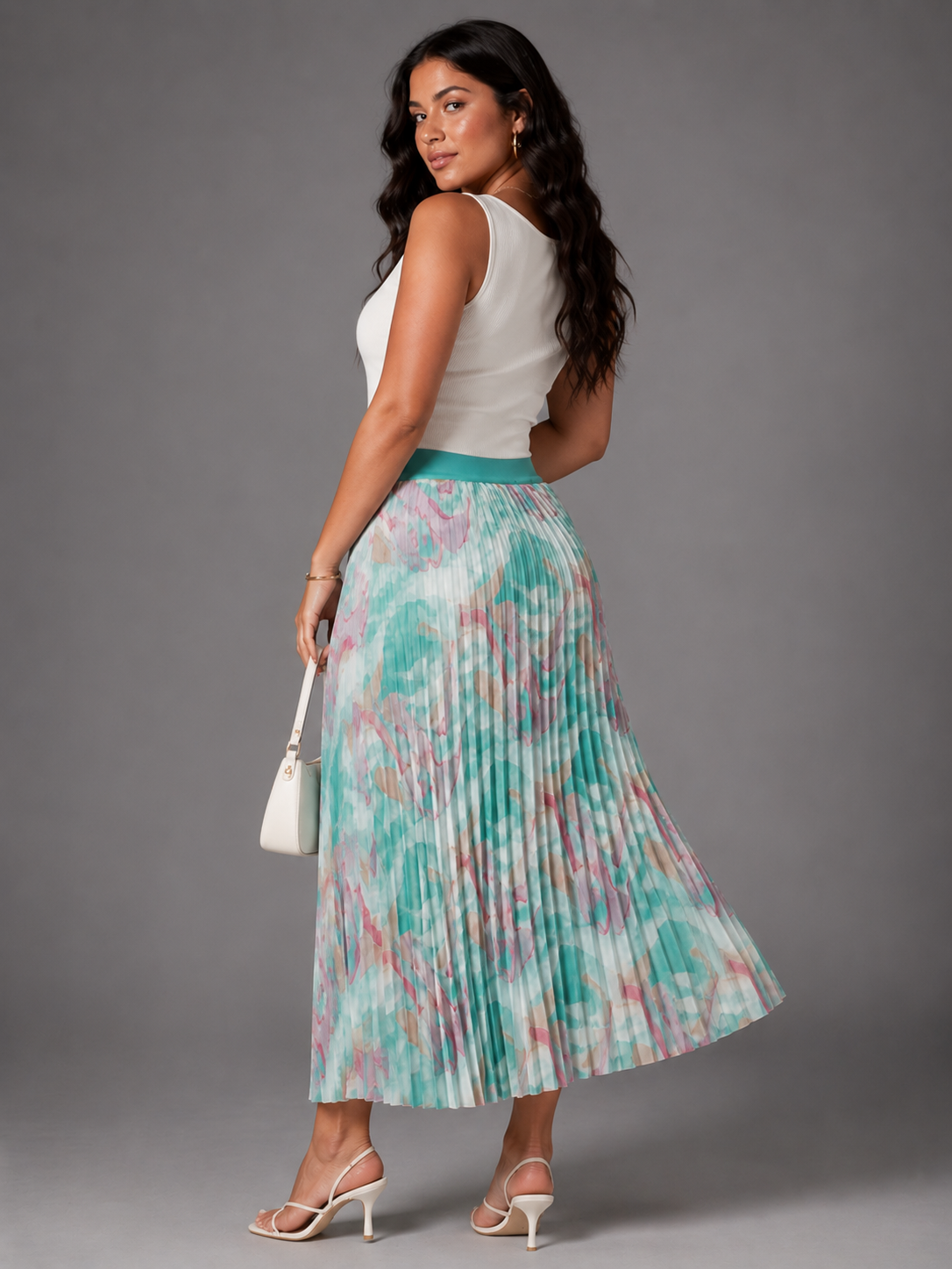 Watercolor print pleated maxi skirt in blue/multi, model walking with flowing movement back, For Her NYC 
