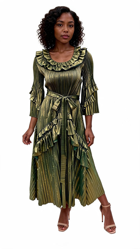 Woman wearing a green metallic pleated midi dress with layered ruffle trim, statement sleeves, asymmetrical hem, and waist tie posing at an angle in heels. For Her NYC