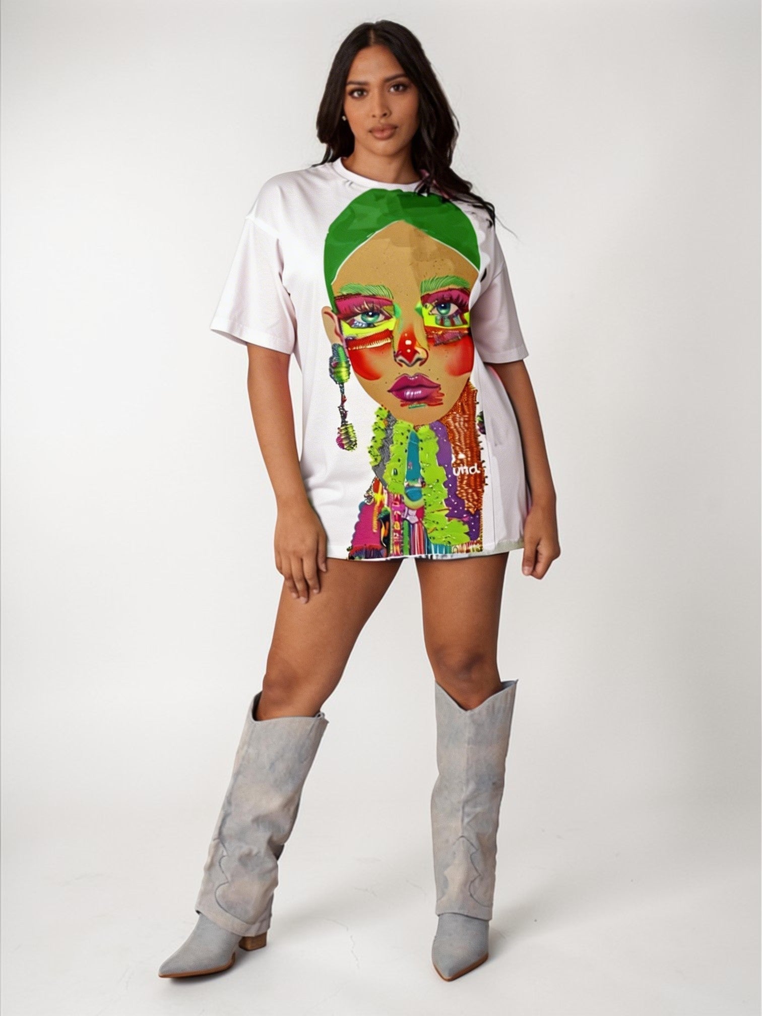 White graphic tee featuring vibrant electric portrait artwork with rhinestone detailing, model standing front view wearing tall boots For Her NYC