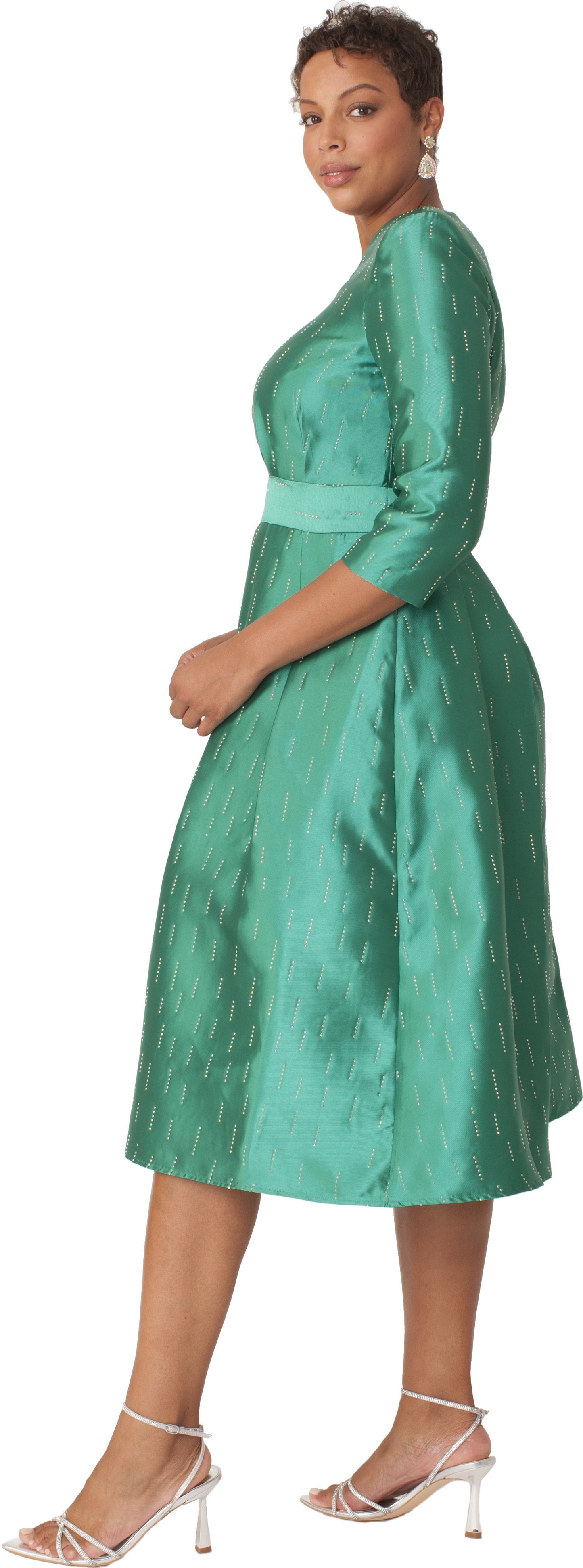 Side view of emerald shimmer A-line tea length dress featuring three-quarter sleeves, defined waist, and softly pleated skirt by Tally Taylor