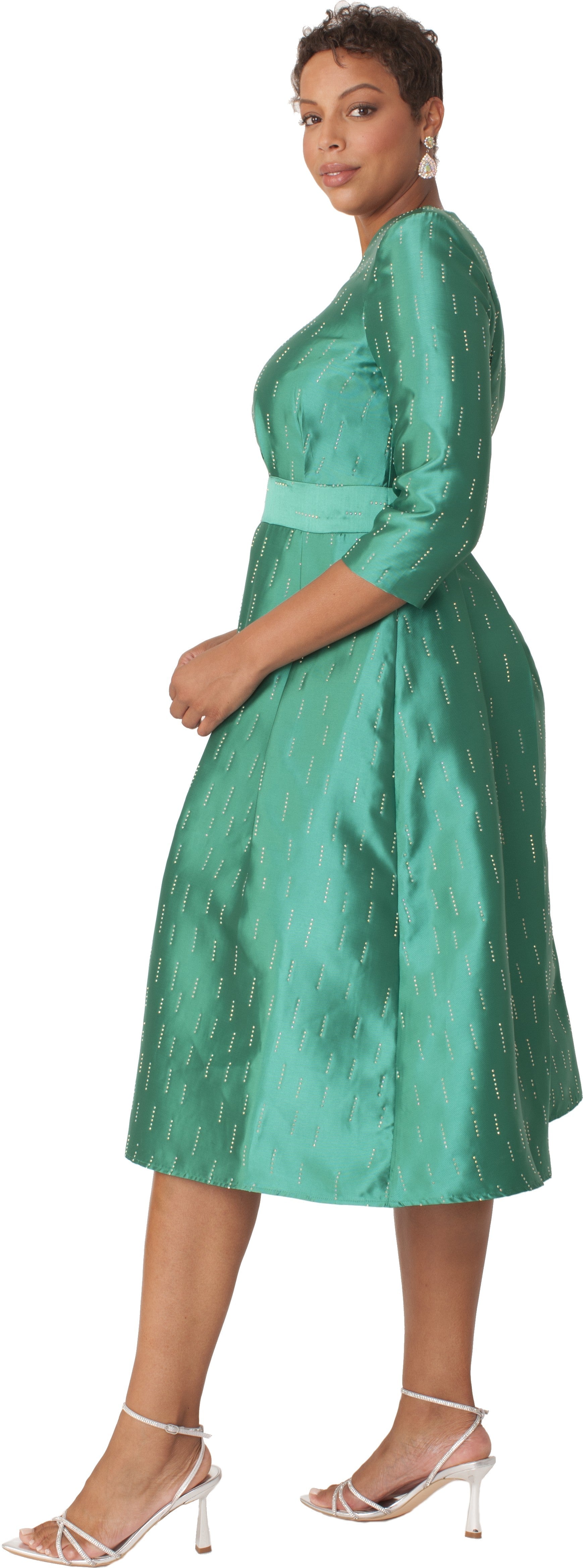 Side view of emerald shimmer A-line tea length dress featuring three-quarter sleeves, defined waist, and softly pleated skirt by Tally Taylor