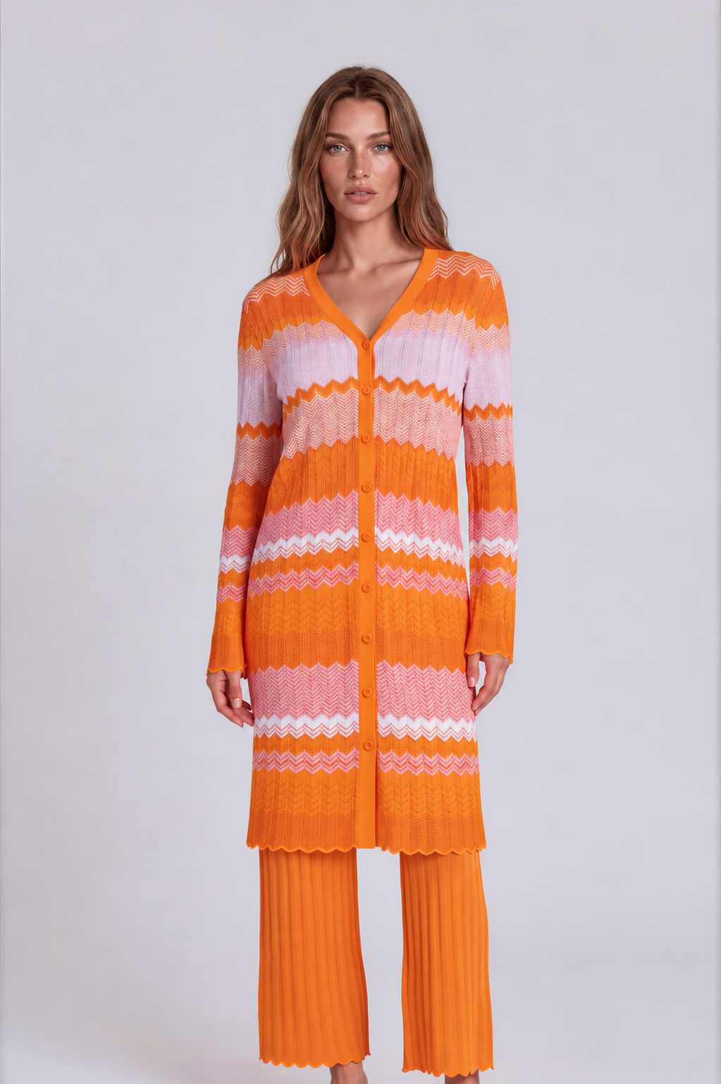 Orange multi chevron knit dress and pant set 51013 front view with model standing angled, button-front long sleeve knit dress layered over matching pants – Tally Taylor