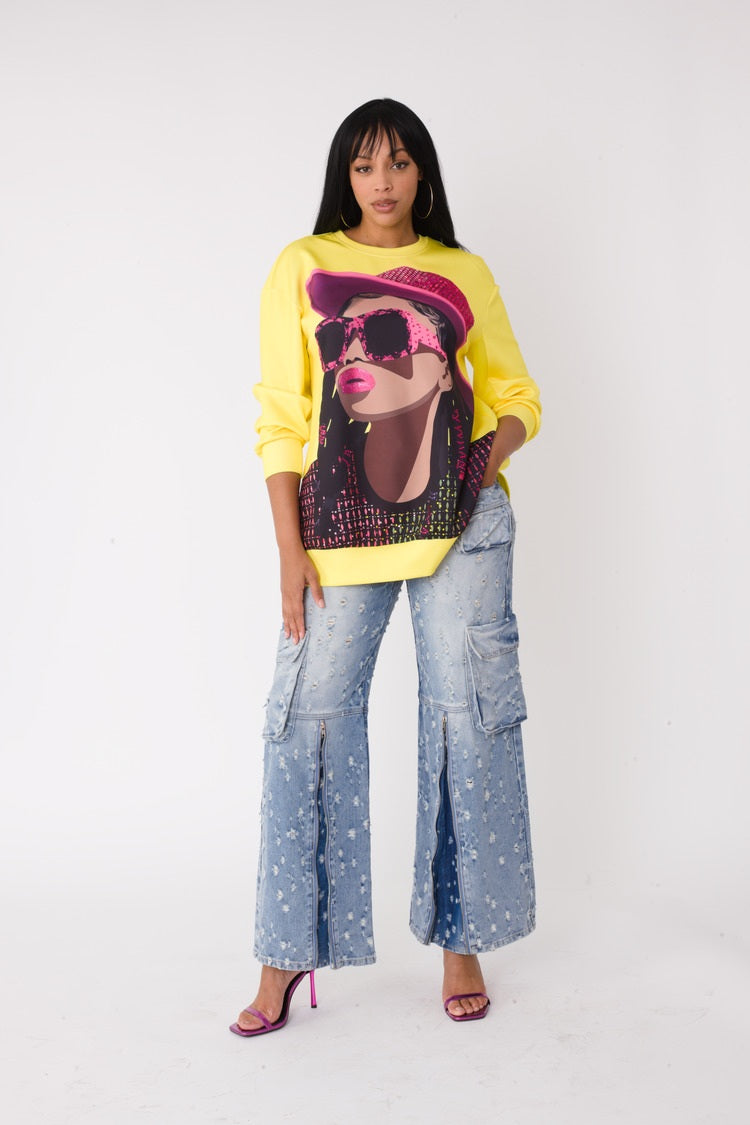 Model wearing the yellow artistic portrait graphic long sleeve t shirt standing front facing, featuring bold portrait print with yellow hat and relaxed fit by For Her NYC
