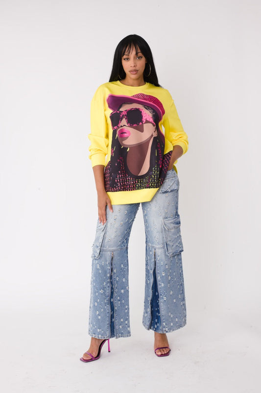 Model wearing the yellow artistic portrait graphic long sleeve t shirt standing front facing, featuring bold portrait print with yellow hat and relaxed fit by For Her NYC