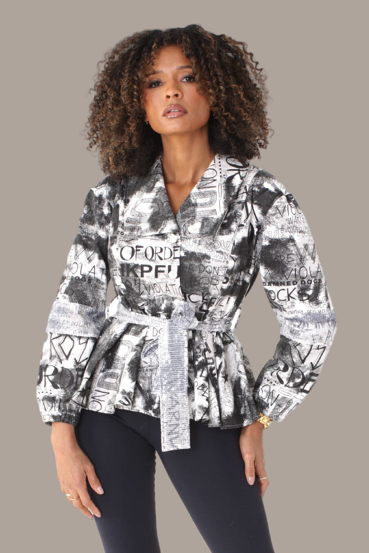 Front view printed peplum jacket with structured waist and bold black and white text print — For Her NYC