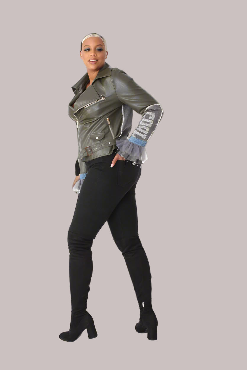 Angled back view of army green faux leather moto jacket with denim patchwork and tulle cuff trimming for streetwear flair.