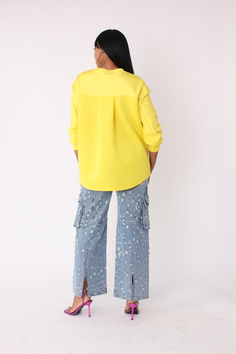Back view of model wearing the yellow artistic portrait graphic long sleeve t shirt showing solid back and relaxed silhouette by For Her NYC