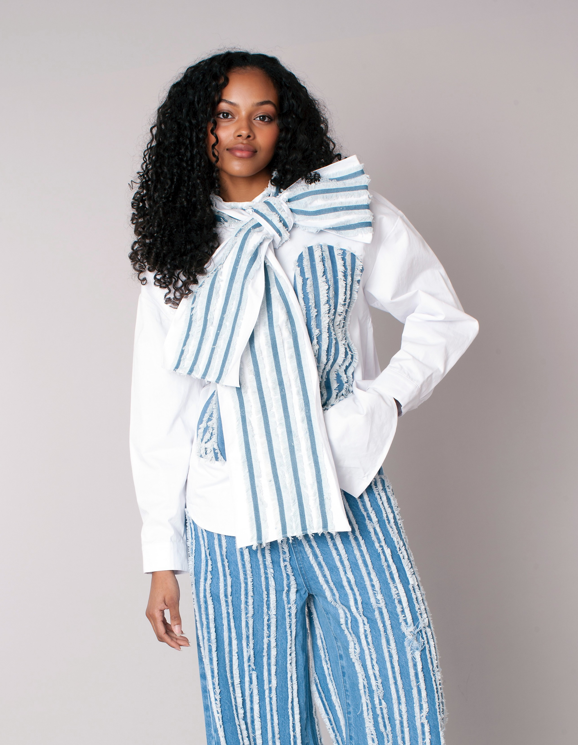 Front view of asymmetric stripe top with statement bow in white and denim For Her NYC