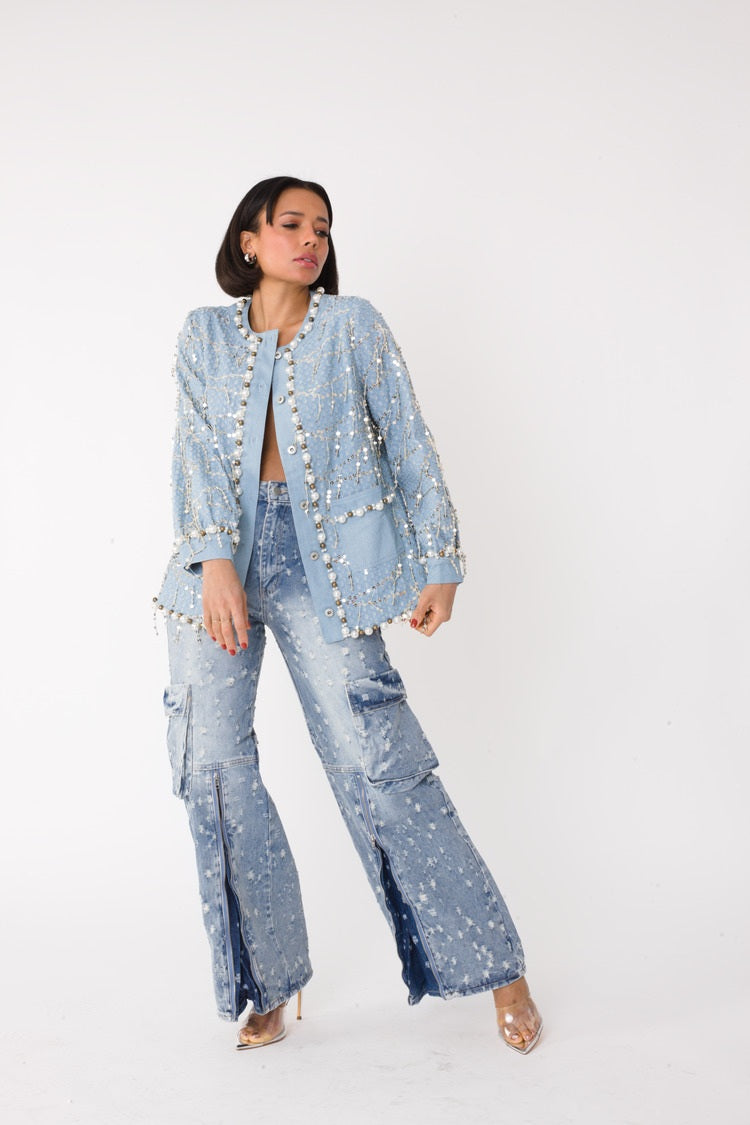Blue denim jacket with sequins and pearl embellishments shown front view styled with matching denim, For Her NYC