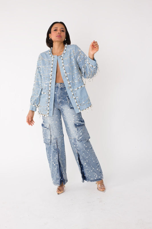 Blue denim jacket with sequins and pearl embellishments shown on model walking forward, front view, For Her NYC