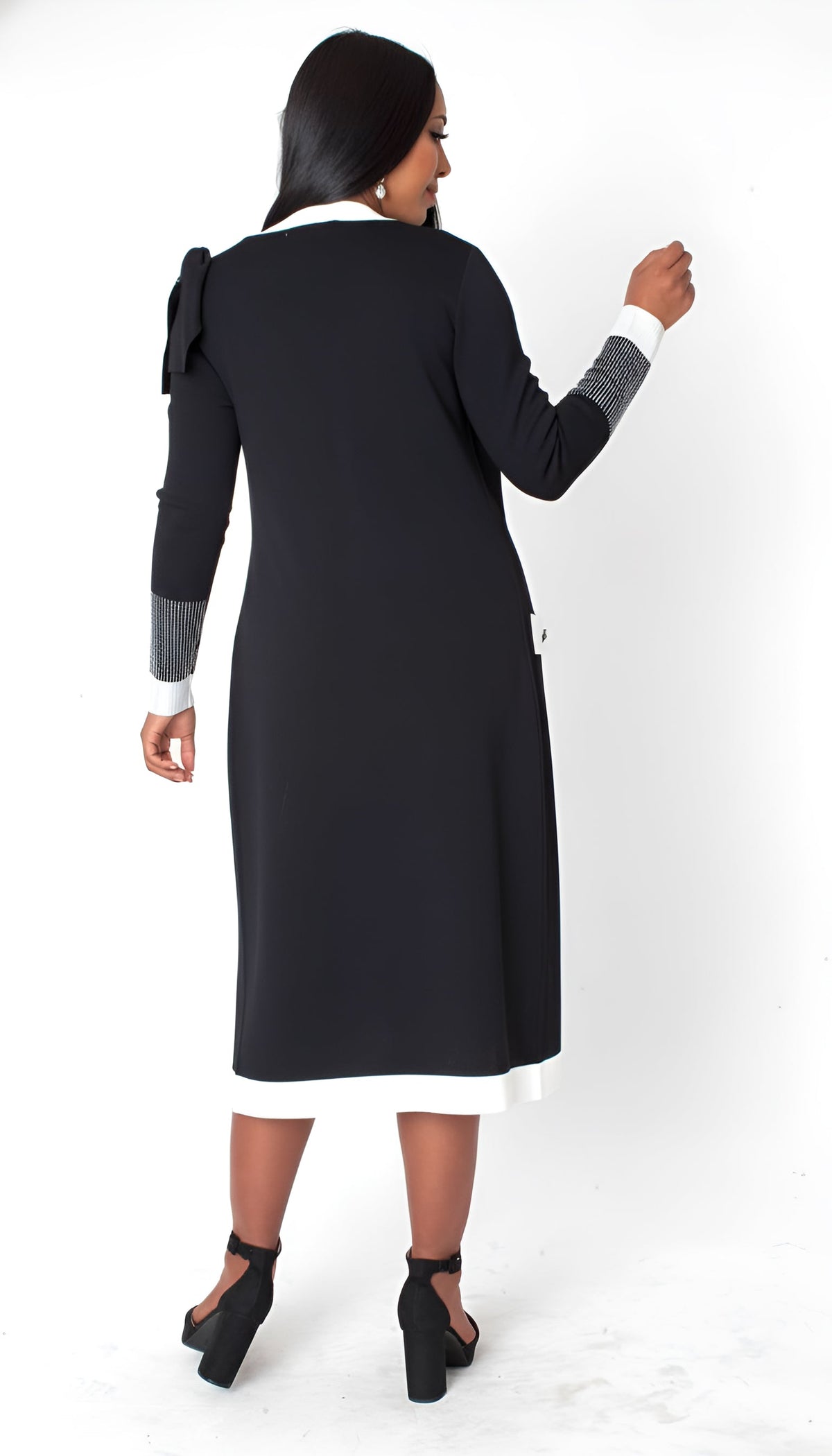 Back view of model wearing the black and white Camille trim knit jacket dress plus size showing clean lines, comfortable knit fabric, and knee length silhouette by Tally Taylor