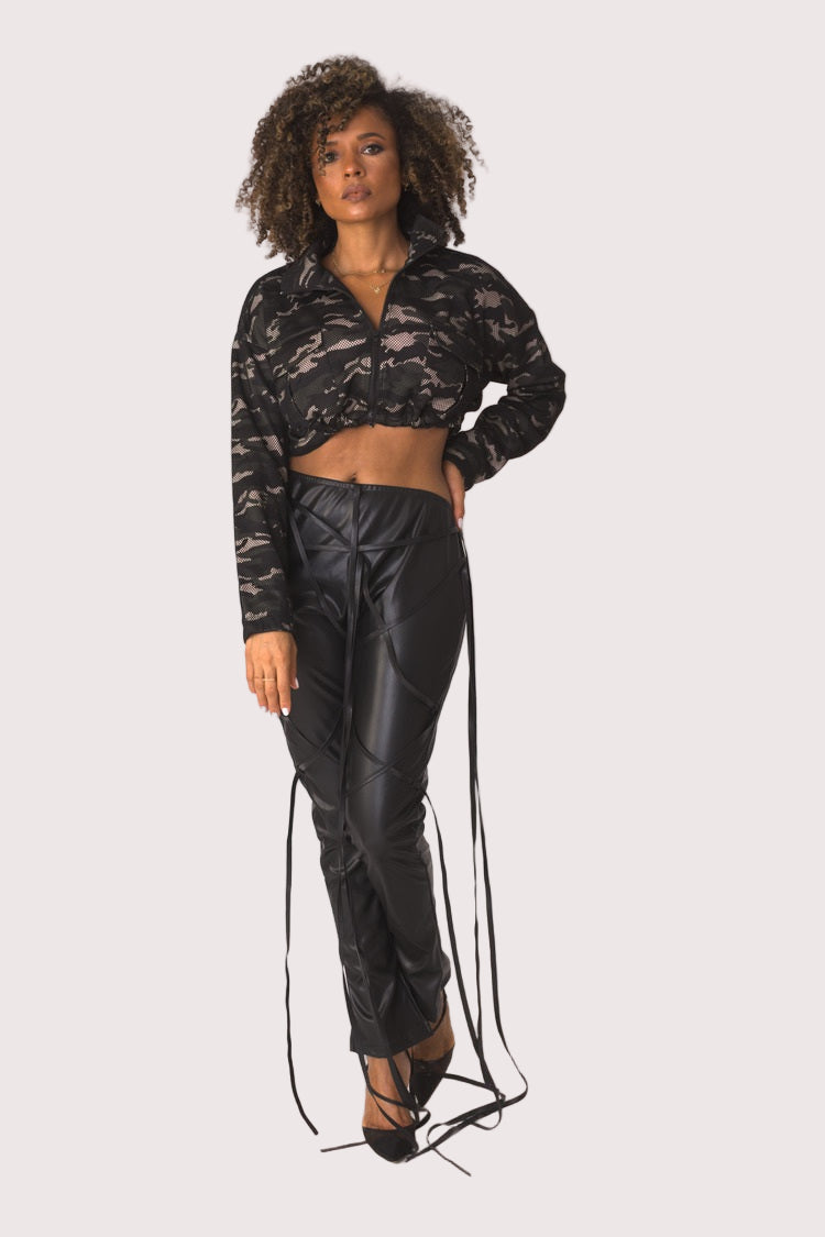 Model wearing camouflage mesh cropped jacket, front-facing hero pose highlighting sheer mesh fabric, cropped length, and bold camo print styling by For Her NYC