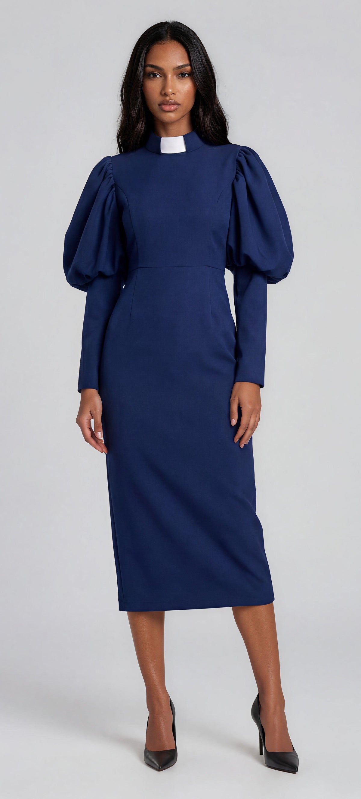 Navy clergy dress with puff sleeves and a classic collar shown in a front standing pose by Tally Taylor.