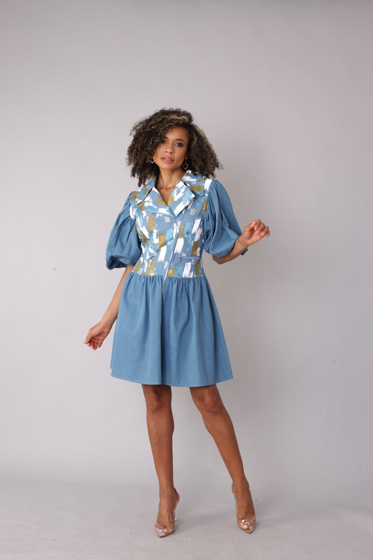 Denim blue puff sleeve dress shown from the front in a full-length standing pose, highlighting the abstract print bodice, puff sleeves, and flared skirt silhouette, casual chic dress by For Her NYC