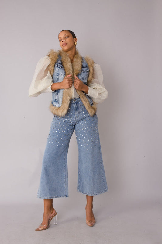 Front view of denim vest with faux fur trim styled over wide leg denim pants highlighting cozy texture and layered silhouette by For Her NYC