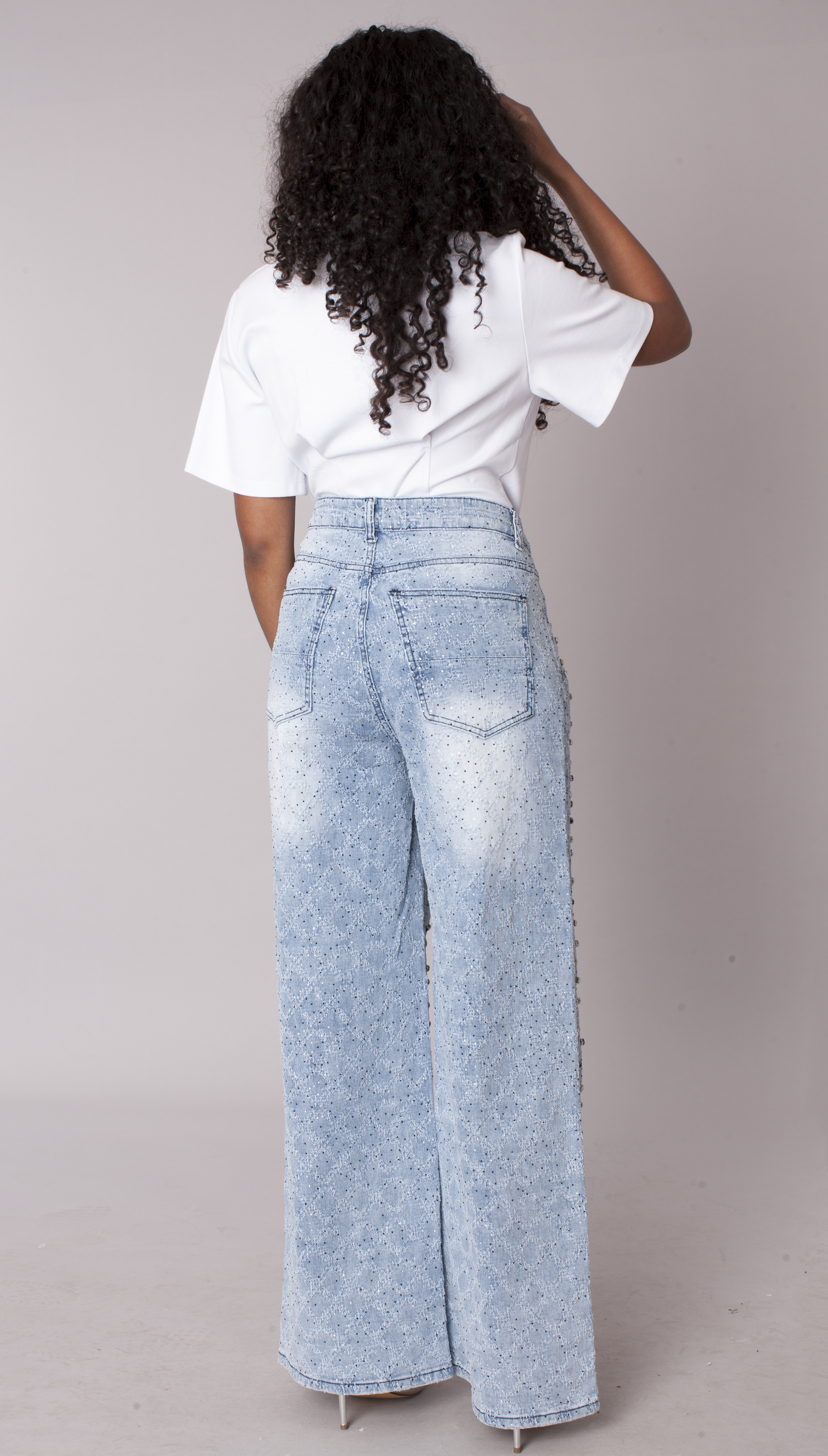 Back view of light wash ombre wide leg jeans with sparkling diamond stud details and high-rise fit – For Her NYC