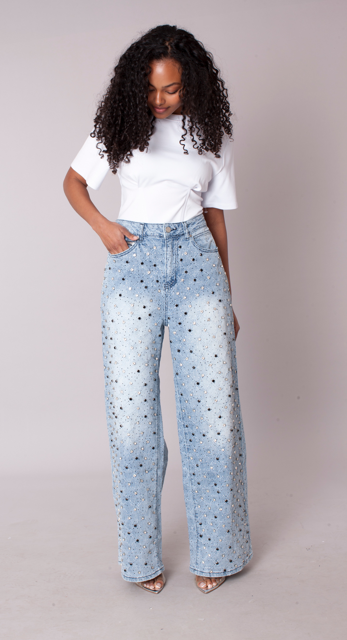Model wearing light wash ombre wide leg jeans with allover diamond stud embellishments, front view – For Her NYC