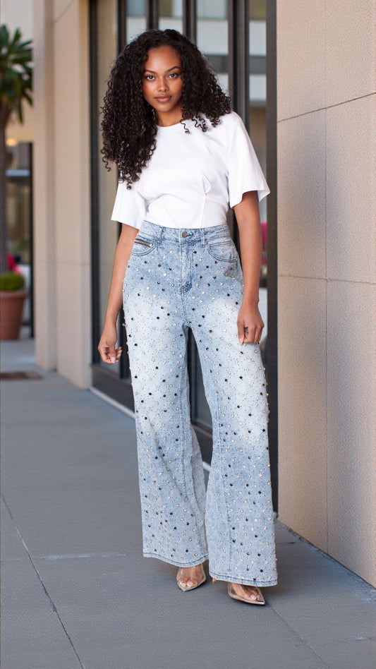 Model wearing diamond stud ombre wide leg jeans styled with a white top outdoors, full outfit view – For Her NYC