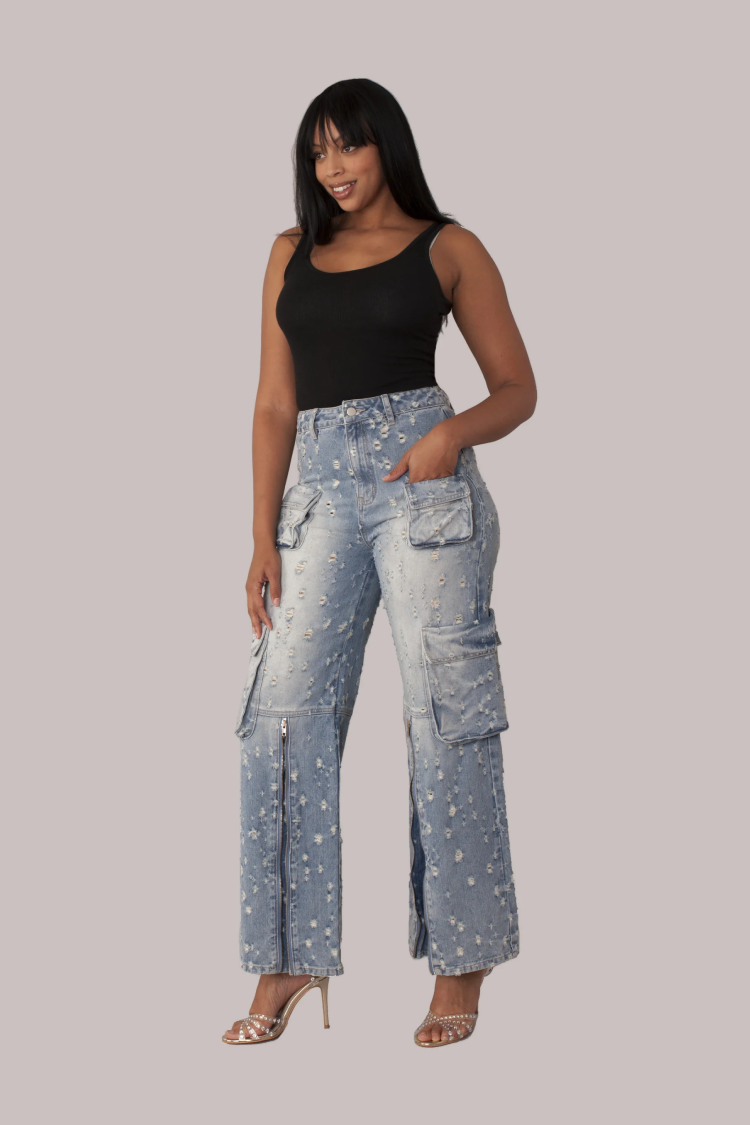 Distressed denim cargo jeans shown on model walking forward, relaxed street style look, For Her NYC