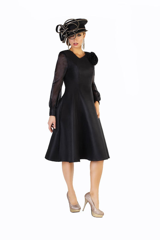 Elegant black A-line dress with sheer sleeves and floral shoulder accent, front view showcasing flattering fit-and-flare silhouette by Tally Taylor