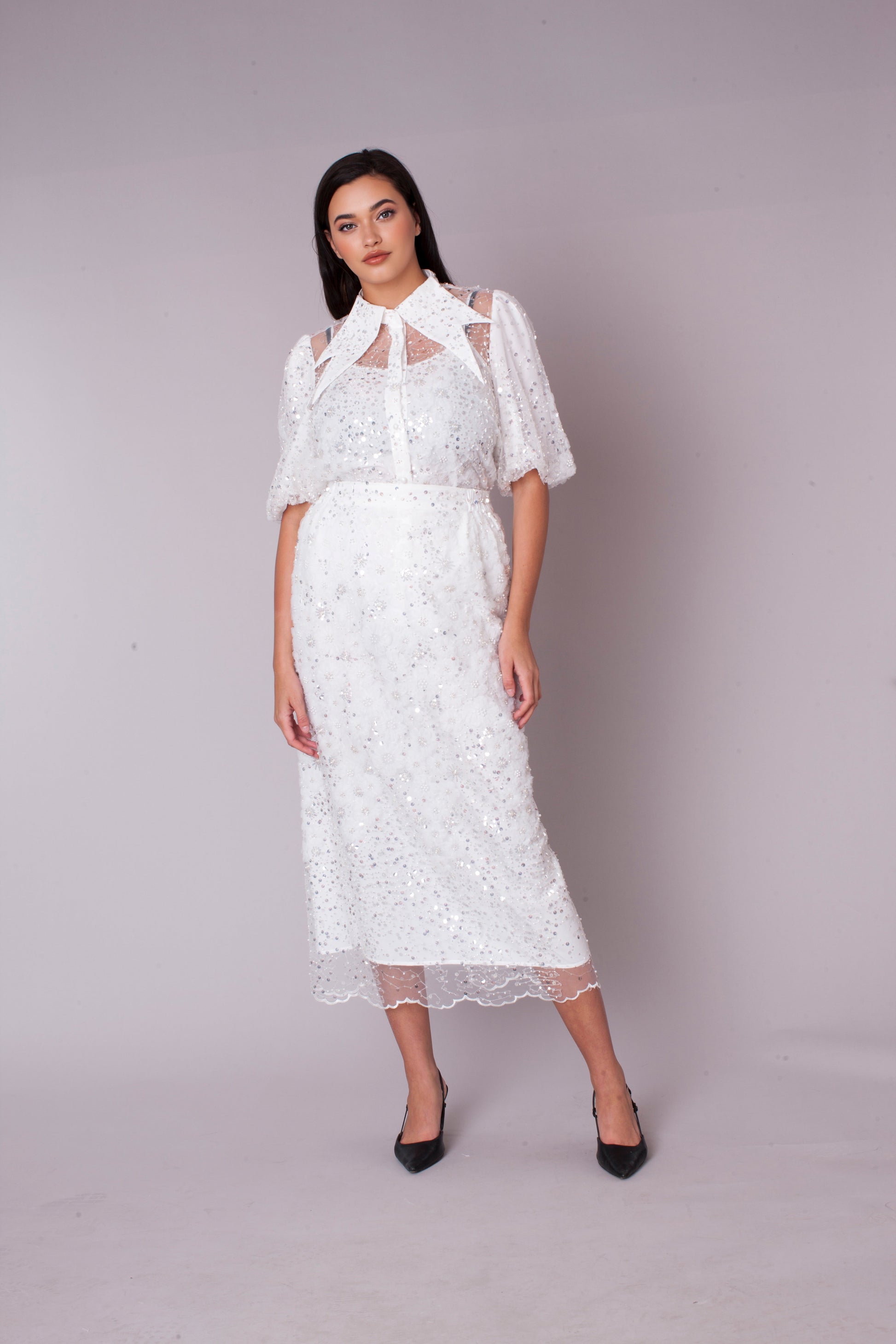 White embroidered sequin organza skirt set with floral detailing, model standing front view, For Her NYC