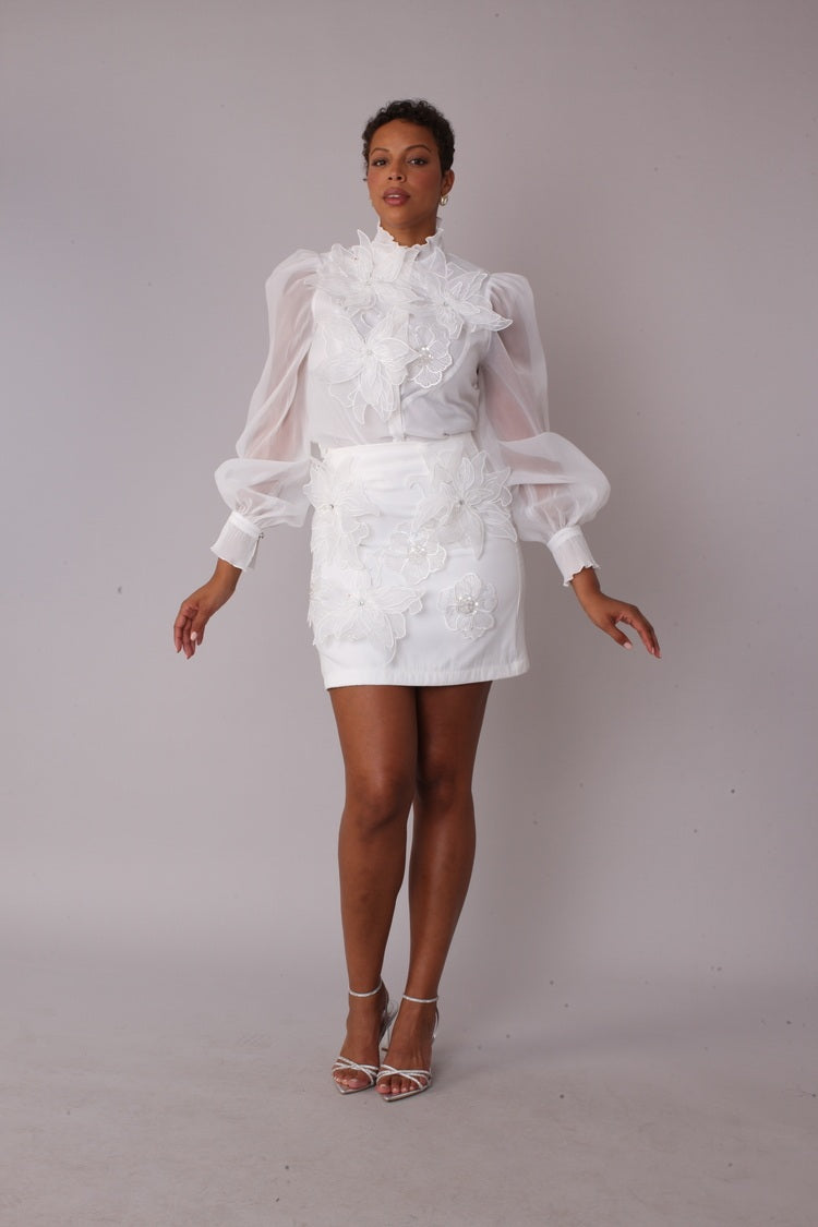 Model wearing Floral Embroidered White Cocktail Skirt in front standing pose showcasing dimensional floral embroidery and mini skirt silhouette, For Her NYC