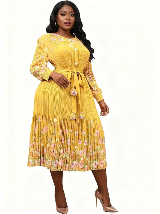 83018 yellow-multi Front view of model wearing a yellow floral pleated midi dress with long sleeves, tie waist, and flowing skirt, For Her NYC