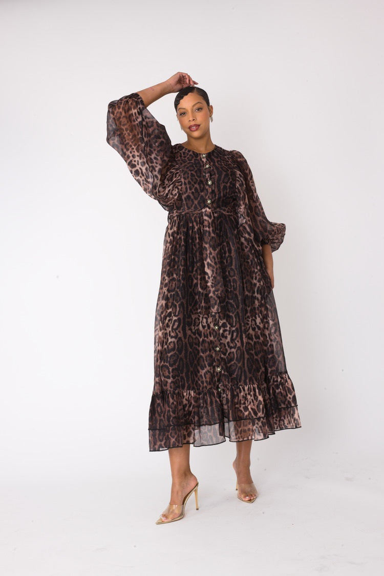 Model hands-up pose showing loose sleeves on leopard-print maxi dress – For Her NYC