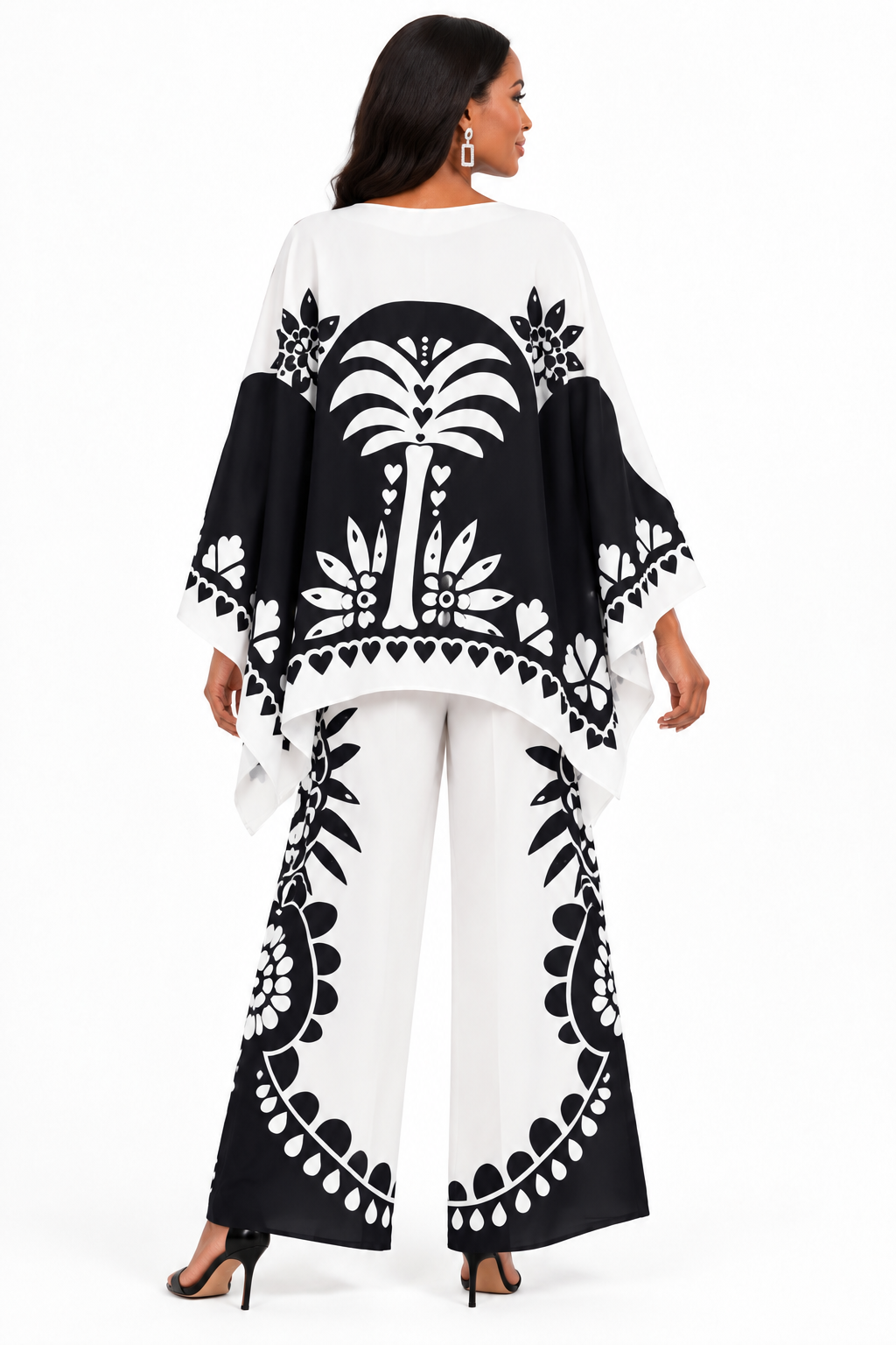 Back view of a model wearing the For Her NYC Black & White Maxi Tunic Pant Set - U0707 with a flowing printed tunic and coordinating wide-leg graphic-print pants
