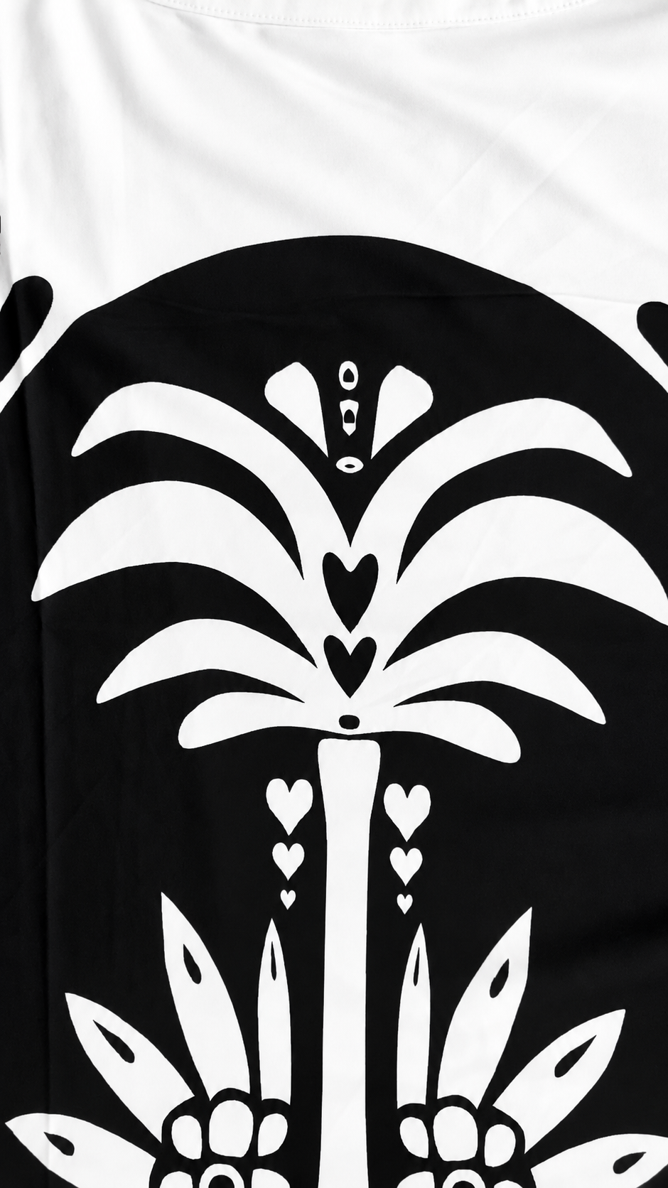 Close-up of a model wearing the For Her NYC Black & White Maxi Tunic Pant Set - U0707, highlighting the bold floral, heart, and abstract graphic print