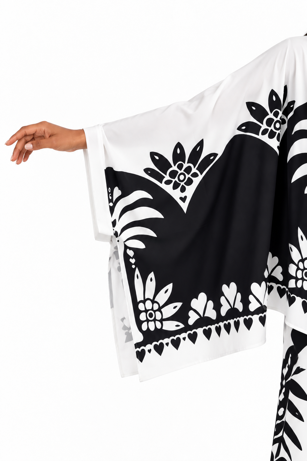 Sleeve close-up of a model wearing the For Her NYC Black & White Maxi Tunic Pant Set - U0707, showing the flowing wide sleeve and bold floral graphic border