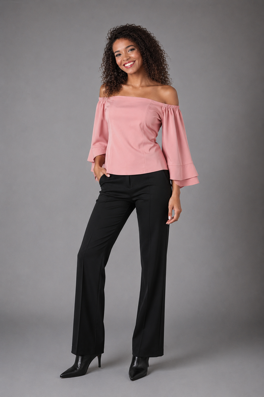 Front view of a model wearing the For Her NYC blush pink off-shoulder bell sleeve blouse