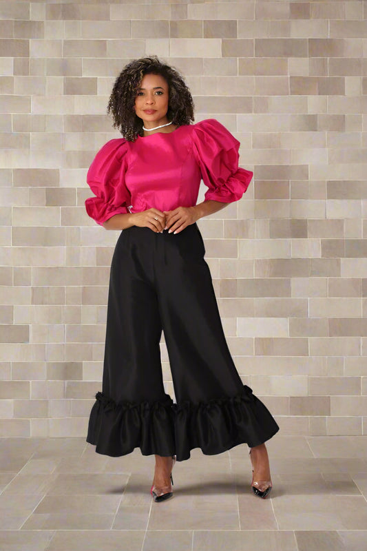 Fuchsia puff sleeve satin blouse in front angle pose against brick wall — For Her NYC