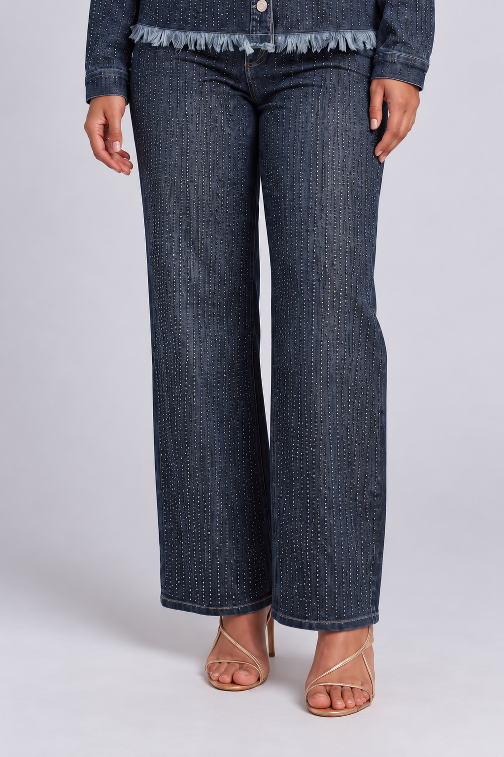 Close front view of a model wearing the For Her NYC Glitter-Effect Flared Denim Pants - 82955 with dense vertical glitter detailing