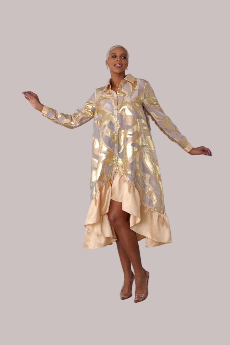 Model in gold metallic organza dress in mid twirl to show flowy movement and layered pleats. For Her NYC.