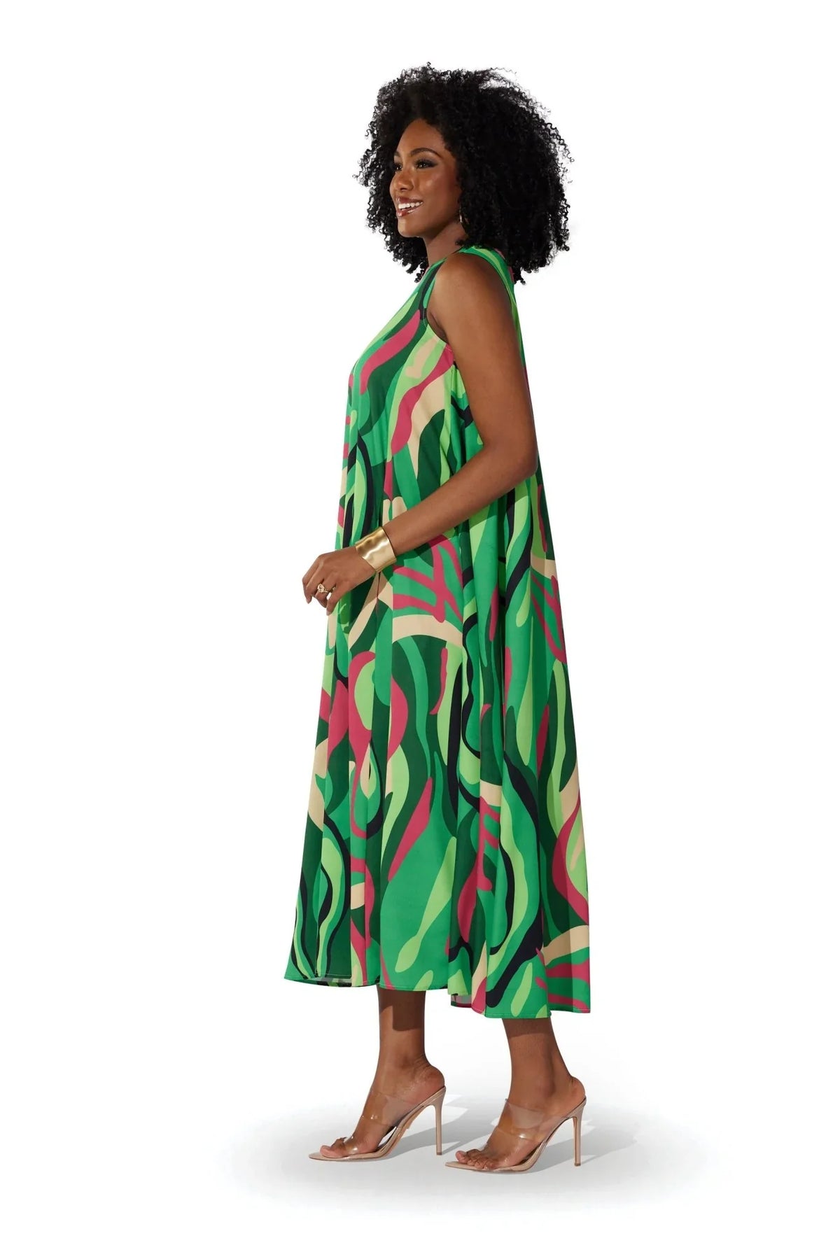 Side view of a model wearing the For Her NYC Oversized Swirls Print Maxi Dress with a vibrant green multicolor abstract swirl print, style S0177.