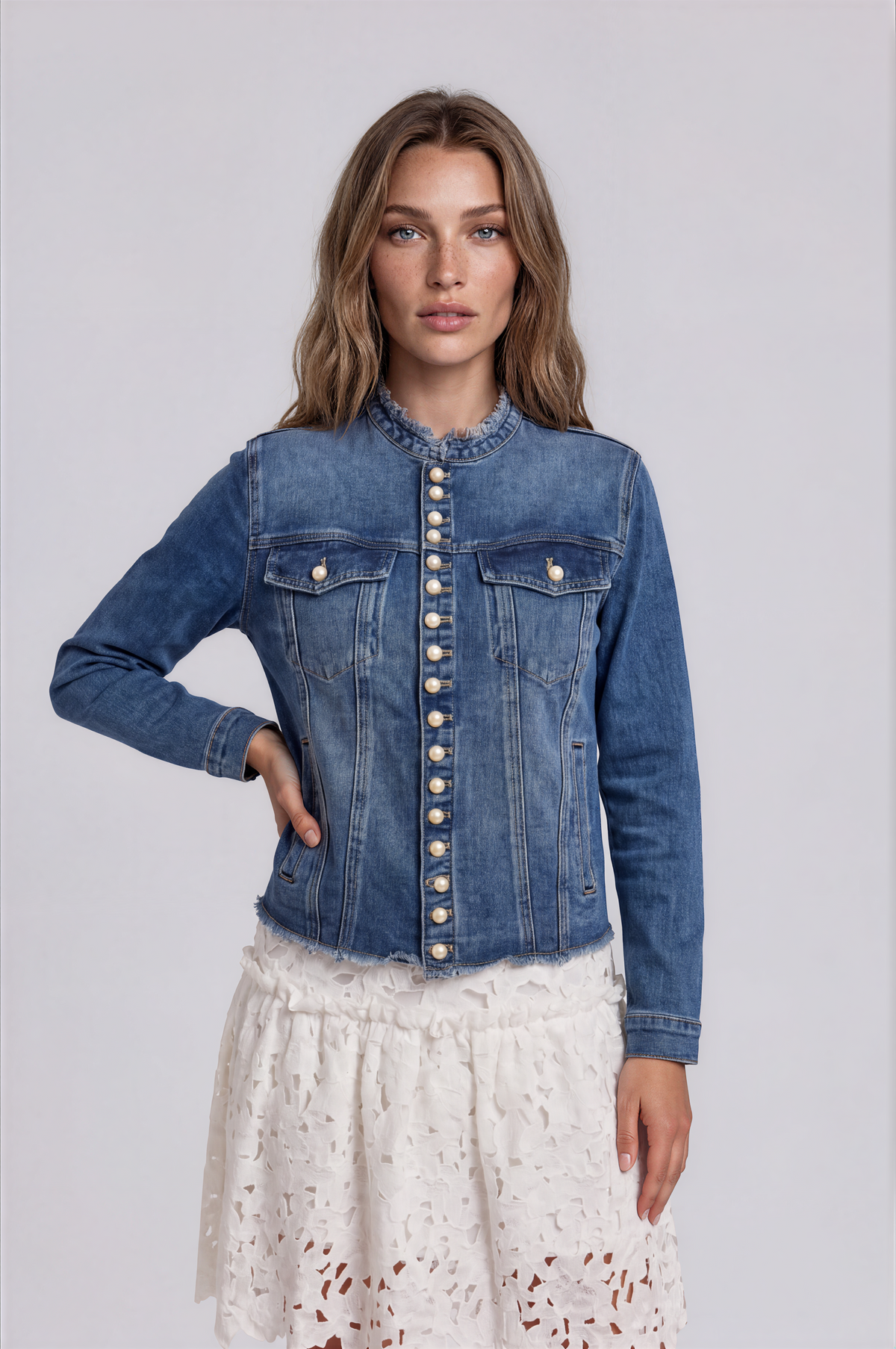 Front view of a model wearing the For Her NYC Pearl Button Denim Jacket - 83040, featuring pearl buttons, chest pockets, and frayed trim